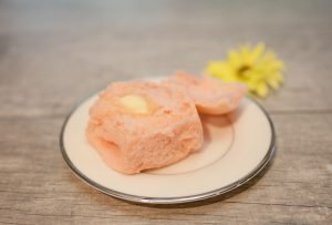 Pink easter roll next to flower