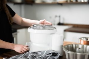 Woman using a Bosch Universal Plus Mixer in a kitchen