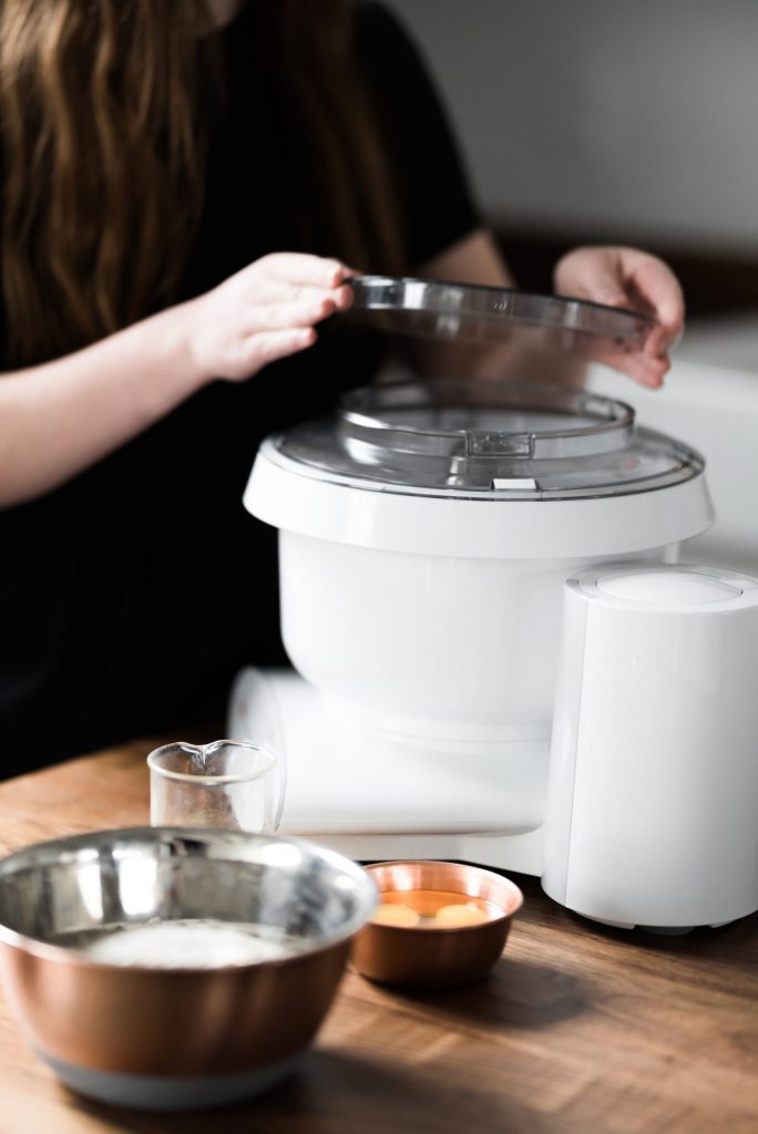 Woman putting lid on Bosch Universal Plus Mixer