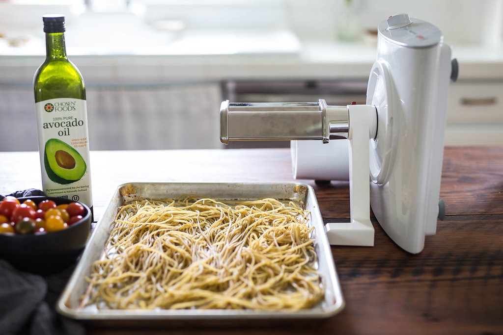 pasta attachment on the Bosch universal plus mixer making pasta in a kitchen