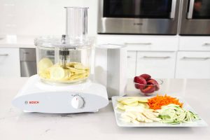 Bosch Universal Plus Large Slicer Shredder with sliced vegetables