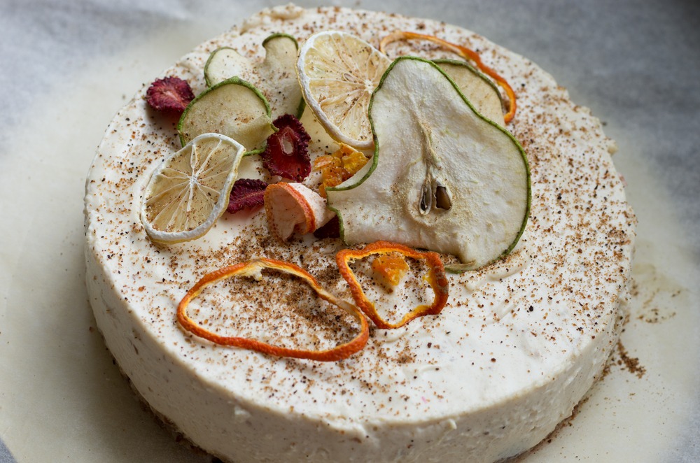 Round white cake topped with dried fruit.